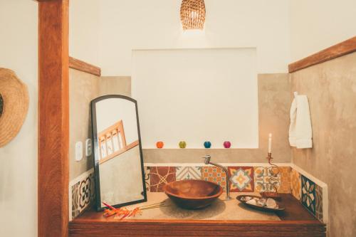 a bathroom with a wooden sink and a mirror at Vila Prosperidade Trancoso in Trancoso