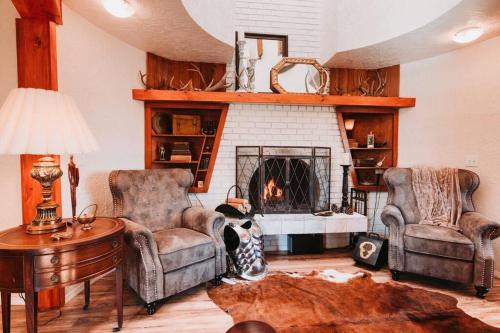 a living room with two chairs and a fireplace at Lavender Castle in Sequim