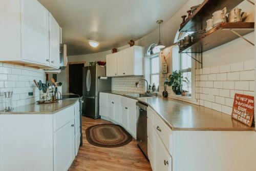 a kitchen with white cabinets and a counter top at Lavender Castle in Sequim