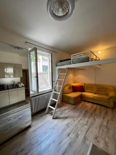 a living room with a bunk bed and a couch at Útulný byt v historickom centre Bratislavy in Bratislava