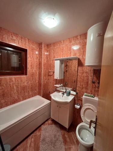 a bathroom with a tub and a toilet and a sink at Villa Grand Jahorina in Jahorina