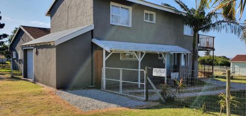 a house with a fence in front of it at Aqua on Newport street in Port Edward