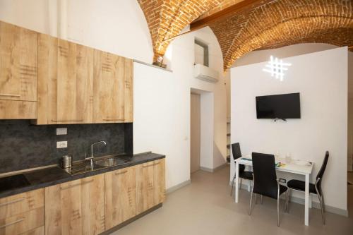 a kitchen with a sink and a table with chairs at Visit Florentia Apartment in Florence