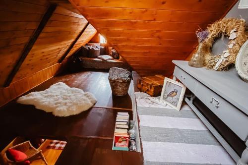 a attic room with a wooden ceiling and a table at Chata Rozárka in Kořenov