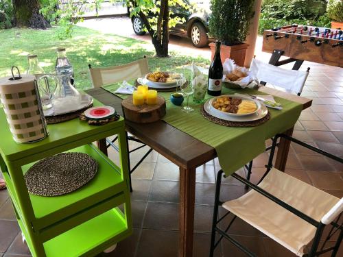 a table with plates of food and a bottle of wine at Mi AN HOME in Paese