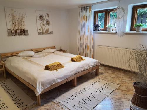 a bedroom with a bed with two pillows on it at Komfortowy apartament nad Zalewem Sulejowskim in Sulejów