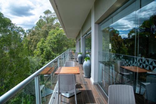 a balcony with a wooden table and chairs on it at Holiday Inn Tlaxcala by IHG in Tlaxcala de Xicohténcatl