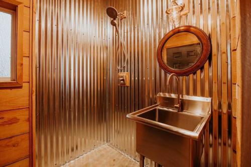 a bathroom with a sink and a mirror at Treehouse-Small Eagles Perch over the water in Port Angeles