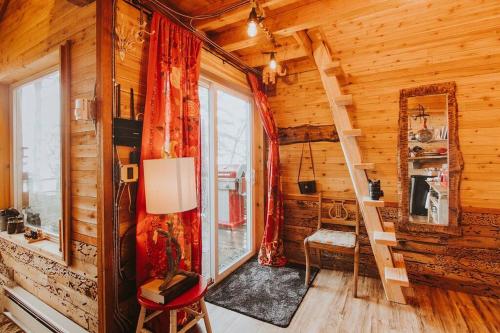 a log cabin with a staircase in a room at Treehouse-Small Eagles Perch over the water in Port Angeles