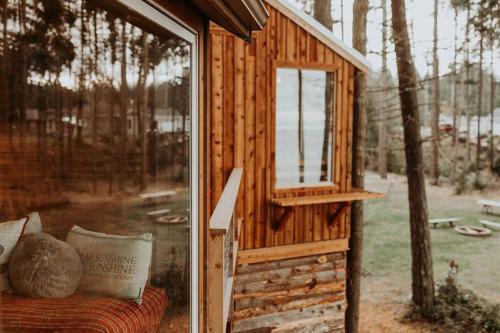 a small wooden house with a window on a couch at Treehouse-Small Eagles Perch over the water in Port Angeles
