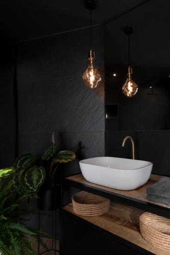 a bathroom with a white bowl sink and lights at #Lavaux in Lutry