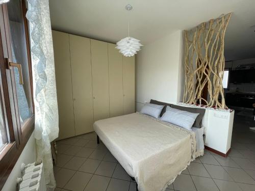 a bedroom with a bed and a chandelier at Apartment "La Balotta" in Bologna