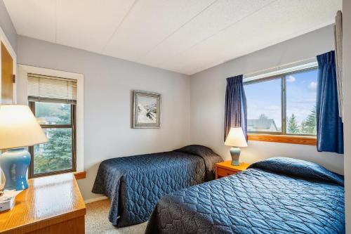 a hotel room with two beds and a window at Pinnacle C10 in Killington