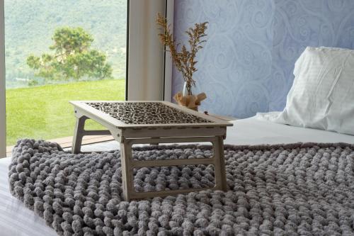 a table sitting on a bed with a blanket at Sukha Resort in La Calera