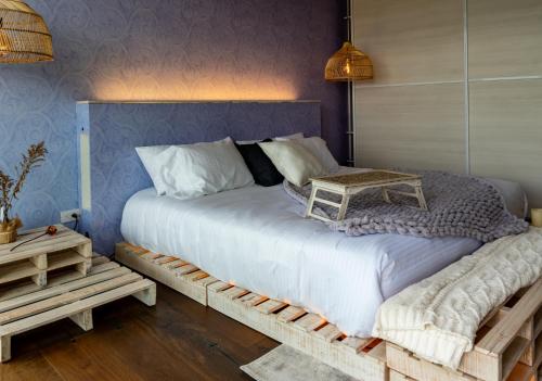 a bedroom with a large bed with a table on it at Sukha Resort in La Calera