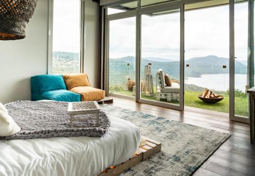 a bedroom with a bed and a view of the water at Sukha Resort in La Calera