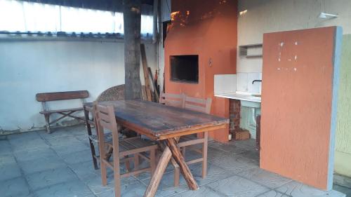 a wooden table and chairs in a kitchen at POUSADA DONA ELVIRA in Capão da Canoa