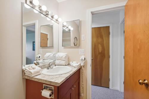 a bathroom with a sink and a mirror at Pinnacle E22 in Killington