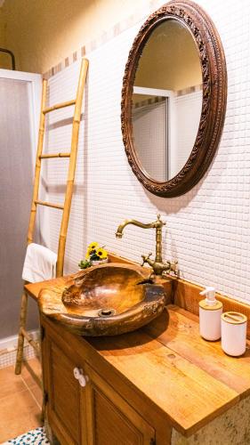 a bathroom with a wooden sink and a mirror at Cal Belló Casa rural in Lleida