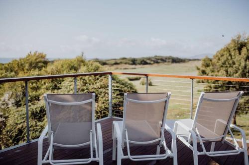 two chairs sitting on top of a deck at Miramar Beach House in Seymour