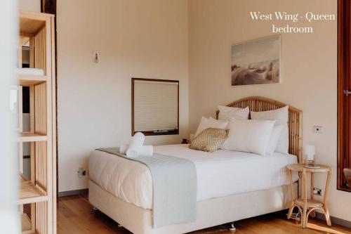 a bedroom with a bed with white sheets and pillows at Miramar Beach House in Seymour