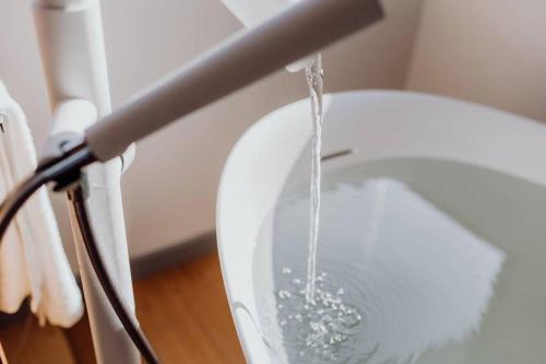 a stream of water pouring into a toilet bowl at Miramar Beach House in Seymour