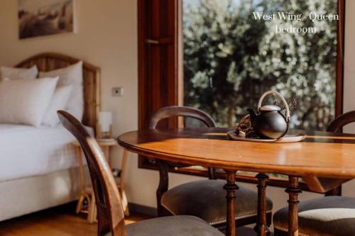 a room with a table and chairs and a bed at Miramar Beach House in Seymour