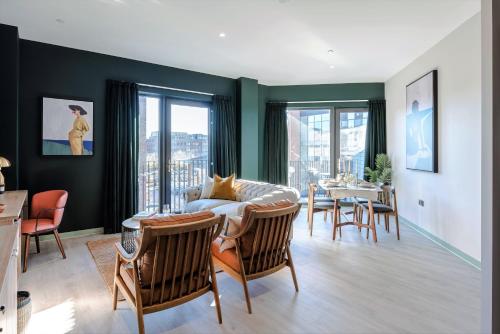 a living room with a couch and a table with chairs at Your Apartment I Milton Keynes in Milton Keynes