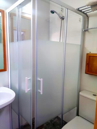 a shower with a glass door in a bathroom at La Casa del Naturalista in El Bosque