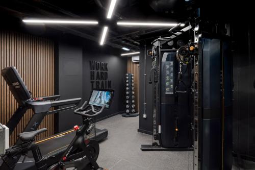 a gym with a treadmill and a bike in a room at Your Apartment I Milton Keynes in Milton Keynes