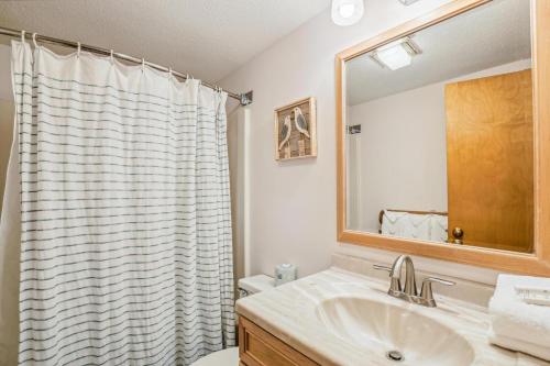 a bathroom with a sink and a mirror at Pinnacle E05 in Killington