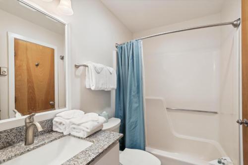 a bathroom with a sink and a toilet and a shower at Pinnacle E25 in Killington