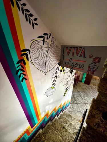 a cake with a rainbow and a peacock on it at Chamos Hostel Cultural in Arraial do Cabo