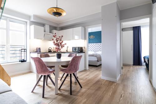 a kitchen and living room with a table and chairs at Baltic Gdansk OLD TOWN in Gdańsk