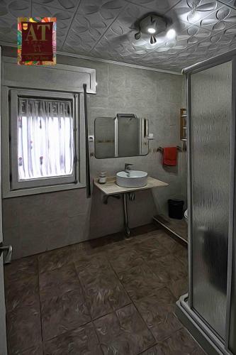 a bathroom with a sink and a mirror at Apartamento turístico Larraga in Monteagudo