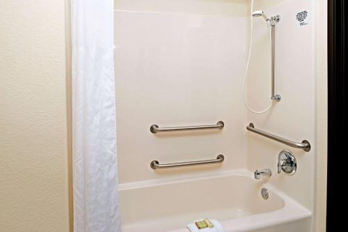 a bathroom with a shower and a bath tub at Super 8 by Wyndham Omaha Eppley Airport/Carter Lake in Omaha