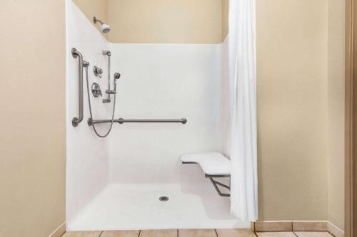 a bathroom with a shower and a toilet at Super 8 by Wyndham Savannah in Savannah
