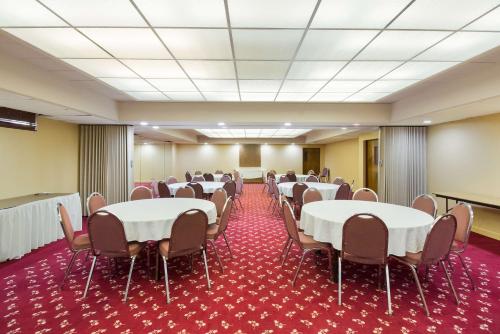 a conference room with tables and chairs and a podium at Best Western Braddock Inn in La Vale