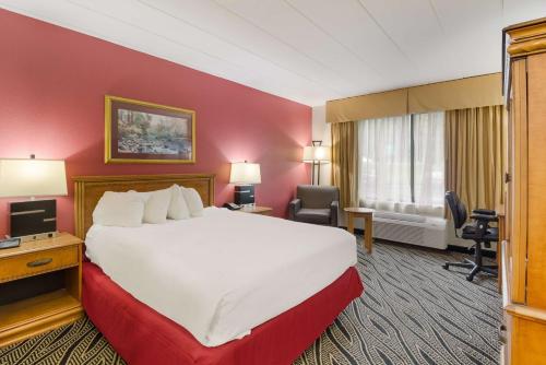 a hotel room with a large bed and a desk at Best Western Braddock Inn in La Vale