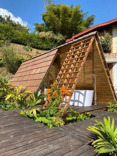 a small wooden house with a roof on a deck at Finca Hotel Tierra Verde in Girardota