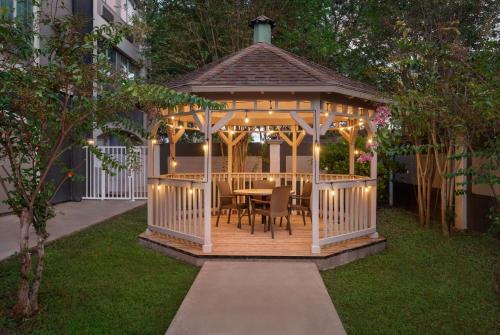a gazebo with a table and chairs in a yard at La Quinta by Wyndham Brownsville North in Brownsville