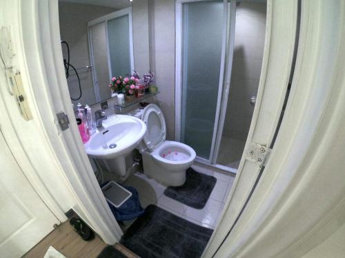 a bathroom with a shower and a toilet and a sink at Azure south urban beach resort near airport in Manila