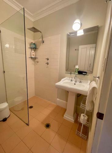 a bathroom with a sink and a shower at Rowan Brae Historic Guesthouse in Blackheath