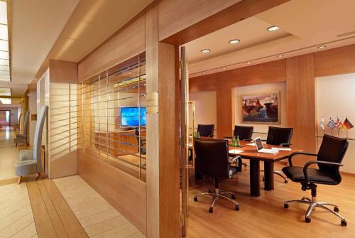 an office with a conference room with a table and chairs at Wyndham Loutraki Poseidon Resort in Loutraki