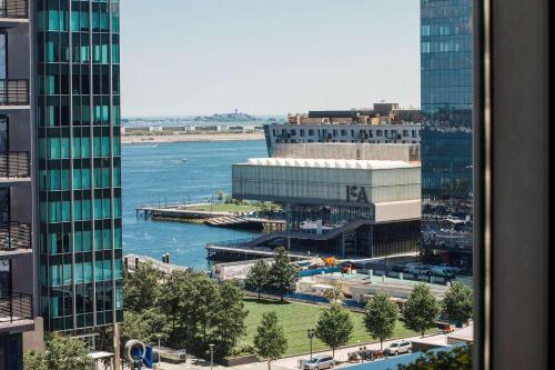 a view of a river between two tall buildings at YOTEL Boston in Boston