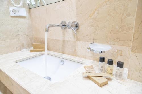 a bathroom with a bath tub and a sink at Hotel Solum Roof Top in Tbilisi City