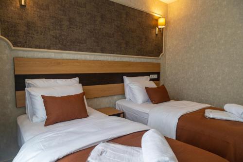 a hotel room with two beds in a room at Hotel Solum Roof Top in Tbilisi City