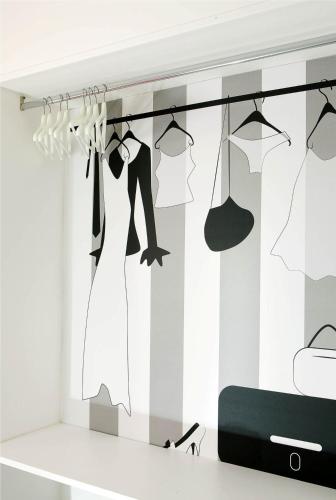 a dressing room with a rack of clothes at Hotel Spicy in Sorrento