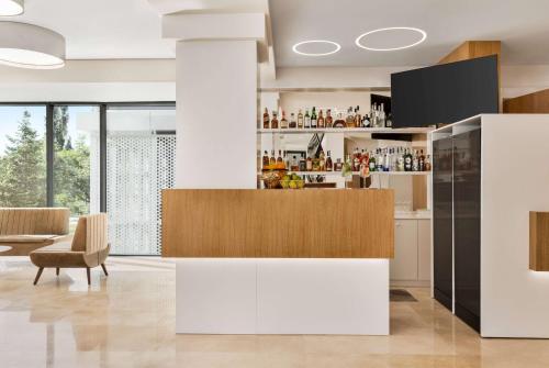 uma cozinha com um bar num quarto em Ramada by Wyndham Slatina Parc em Slatina