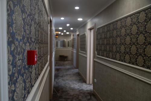 a hallway with a red box on a wall at Hotel Solum Roof Top in Tbilisi City